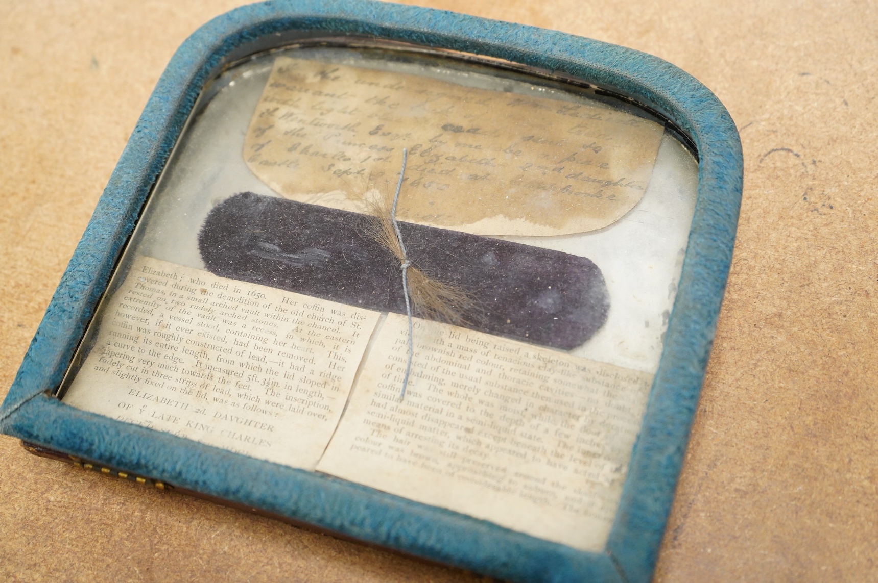 By repute, a lock of hair taken from the body of Princess Elizabeth Stuart (28 December 1635 - 8 September 1650), believed to have been removed from her exhumed remains in the mid 19th century, framed and sold at that ti